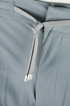 Seafoam grey drawstring pants with knotted cord and metal aglets at waist