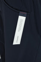 Dark navy technical stretch pants with waistband label near center front.