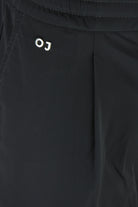 Black technical stretch pants with OJ logo near front pocket
