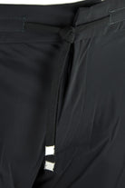 Black drawstring waist technical stretch pants with hanging care tag