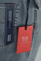 Tramarossa denim jeans with blue label and red hangtag on grey fabric