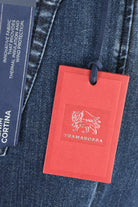 Dark blue fleece denim jeans with red Tramarossa hang tag attached.
