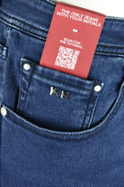 Blue denim jeans with inner-pocket label and metal button rivets