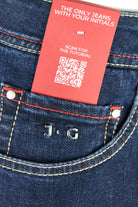 Dark blue denim jeans with JTG branding on the front coin pocket.
