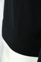 Black merino wool jumper hem with ribbed knit bottom cuff