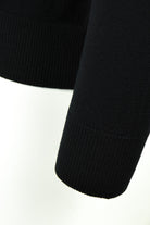 Black merino wool ribbed knit sleeve cuff