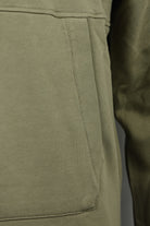 Olive green kangaroo pocket panel with stitched seam detail