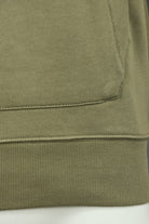 Olive green sweatshirt bottom hem with waistband ribbing and pocket seam