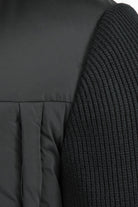 Black rib-knit sleeve section on padded jacket