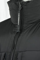 Black hooded padded jacket with center zipper tape marked C.P. COMPANY