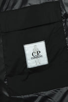 C.P. COMPANY logo label on the chest of a black padded jacket