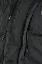 Close-up of black jacket front seams with dual zips and drawstring cords