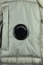 C.P. Company rubber logo patch on quilted hooded jacket front panel