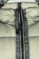 Puffer jacket front with black zipper and vertical C.P. COMPANY branding tape