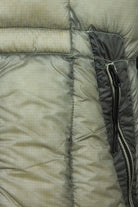 Quilted puffer jacket side panel with black zipper and stitched baffles