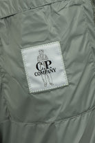 C.P. Company woven logo label on inner pocket of hooded puffer jacket