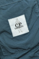 Blue overshirt with embroidered C.P. Company logo patch