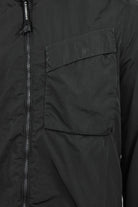 Black zipped overshirt with chest flap pocket and visible front zipper