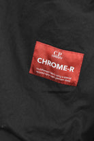 Black overshirt interior label reading C.P. CHROME-R