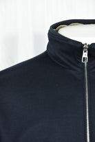 Dark blue jacket chest close-up with full-zip and stand collar
