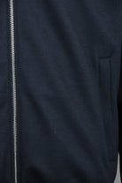 Dark blue padded wool jacket with center zipper and welt chest pocket