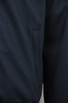 Dark blue padded wool jacket with side pocket and tapered hem