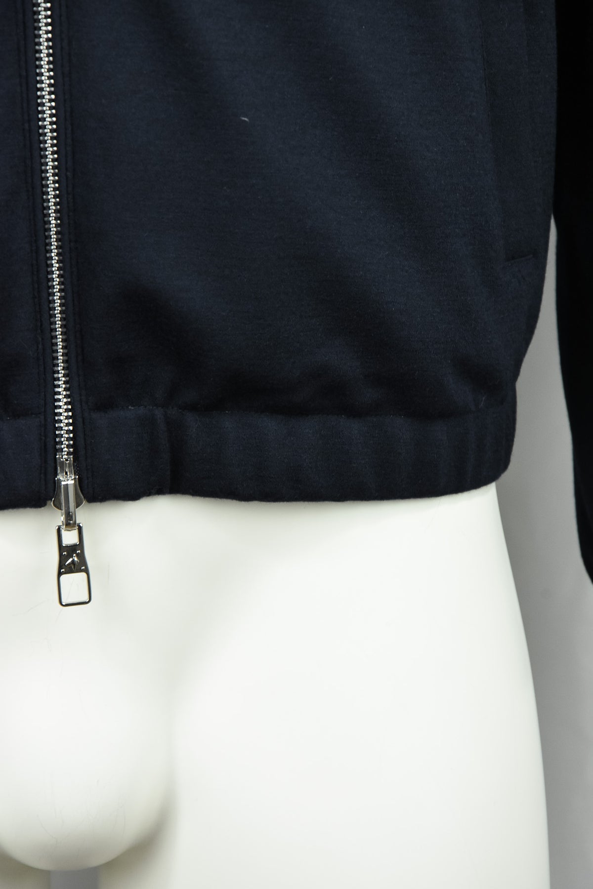 Dark blue padded wool jacket with metal zipper pull, ribbed cuff and straight hem