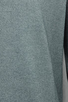 Petrol blue knit fabric cardigan panel with smooth, textured knit surface.