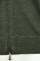 Bottom front view of bottle green cardigan with zipper and knit hem detail