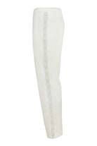 White velour track pants, side view with elastic waistband and straight leg