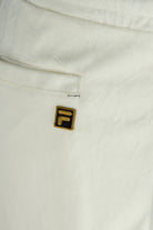 White velour track pants with embroidered F logo patch and seam detail