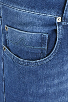 Close-up of the front pocket, coin pocket and rivets on mid-blue denim jeans