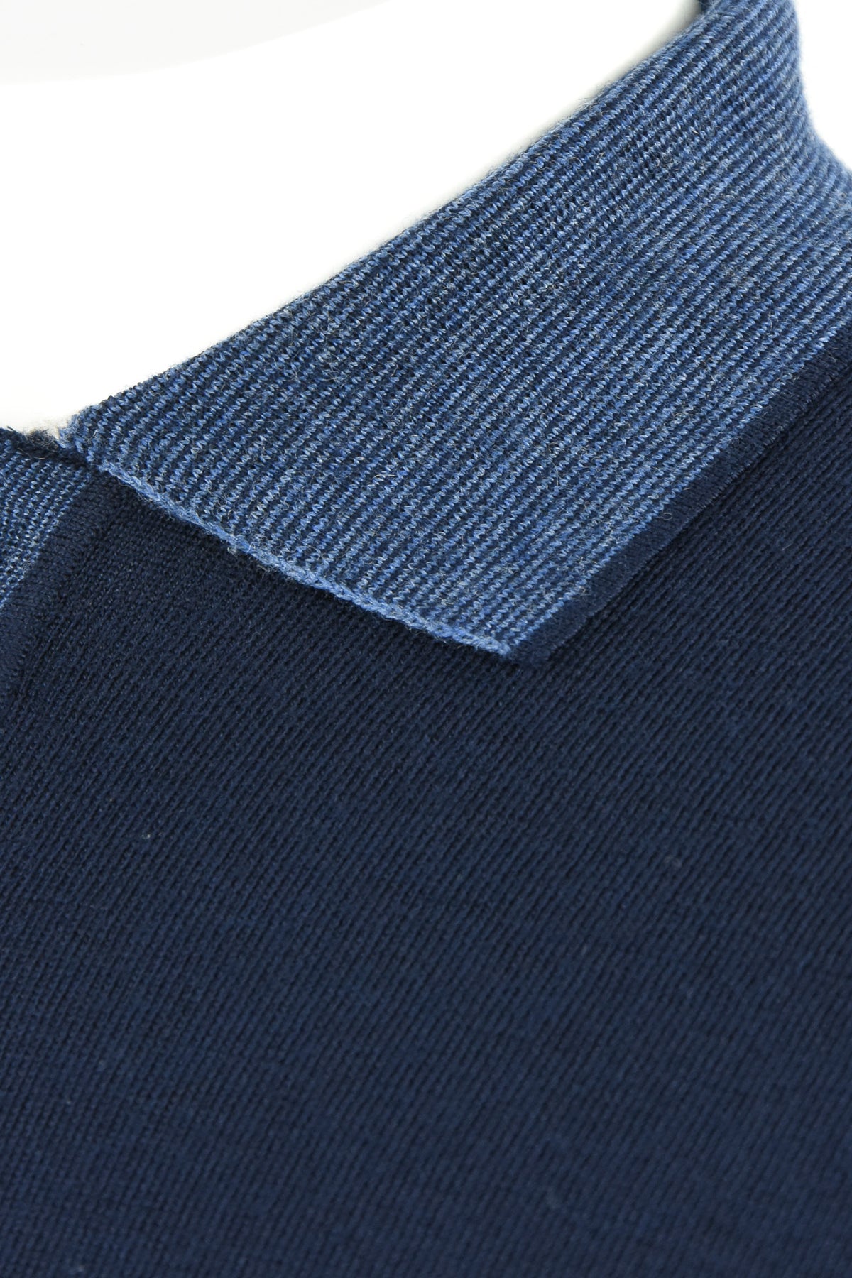 Blue textured contrast collar on a navy wool polo