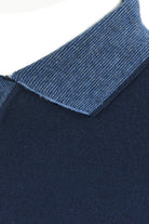 Blue textured contrast collar on a navy wool polo