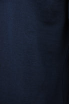 Close-up of the fine knit texture on a navy wool polo