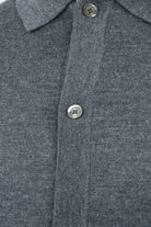 Close-up of the cardigan's gray melange knit and button placket