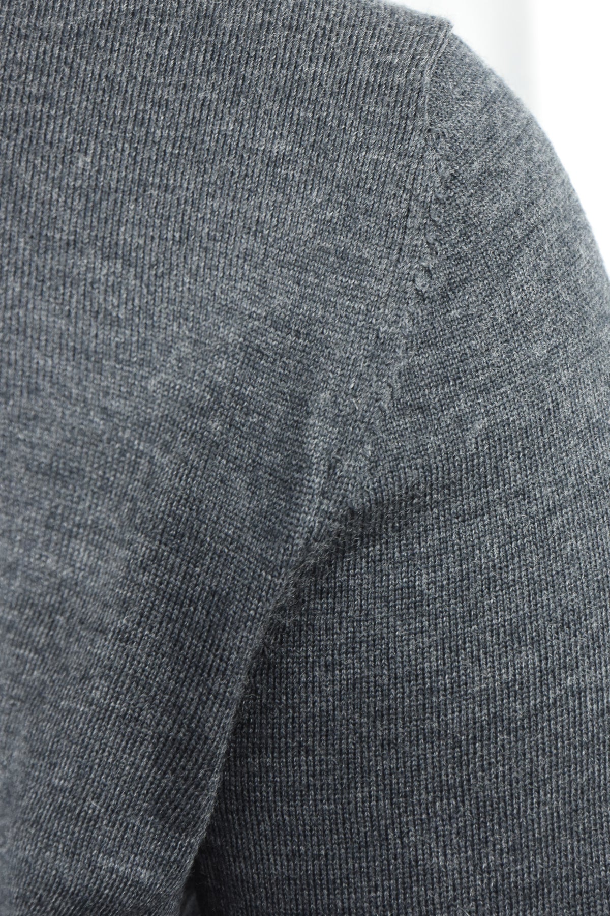Close-up of the cardigan's merino knit and shoulder seam