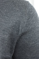 Close-up of the cardigan's merino knit and shoulder seam
