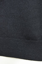 Close-up of the jumper's ribbed hem and knit texture