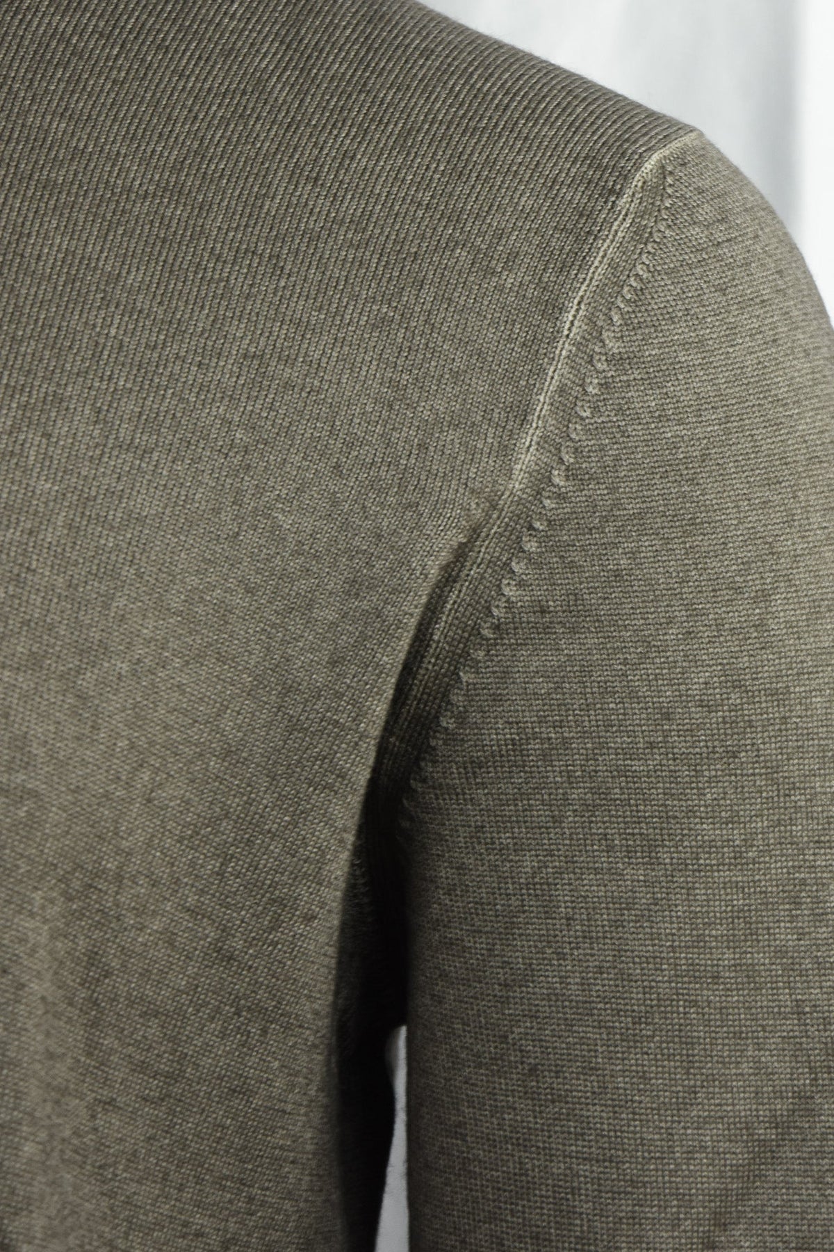 Close-up of the jumper's shoulder seam and knit texture