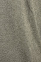 Close-up of the jumper's fine garment-dyed knit texture in light brown