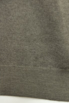 Close-up of the jumper's ribbed hem and knit texture