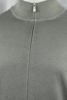 Grey-beige cardigan close-up showing the stand collar and front zipper