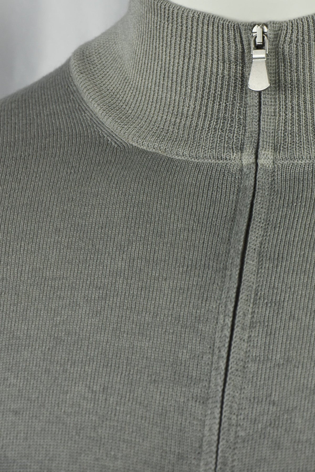 Close-up of the cardigan's ribbed collar and metal zipper pull