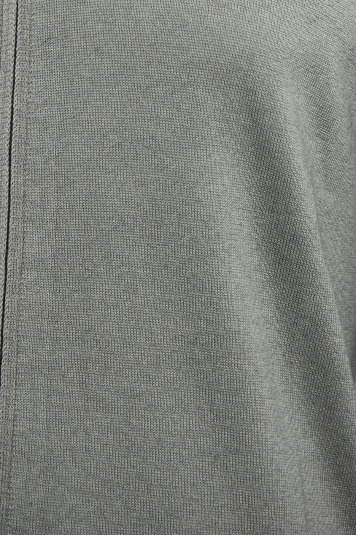 Close-up of the cardigan's fine grey-beige knit fabric