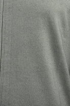 Close-up of the cardigan's fine grey-beige knit fabric