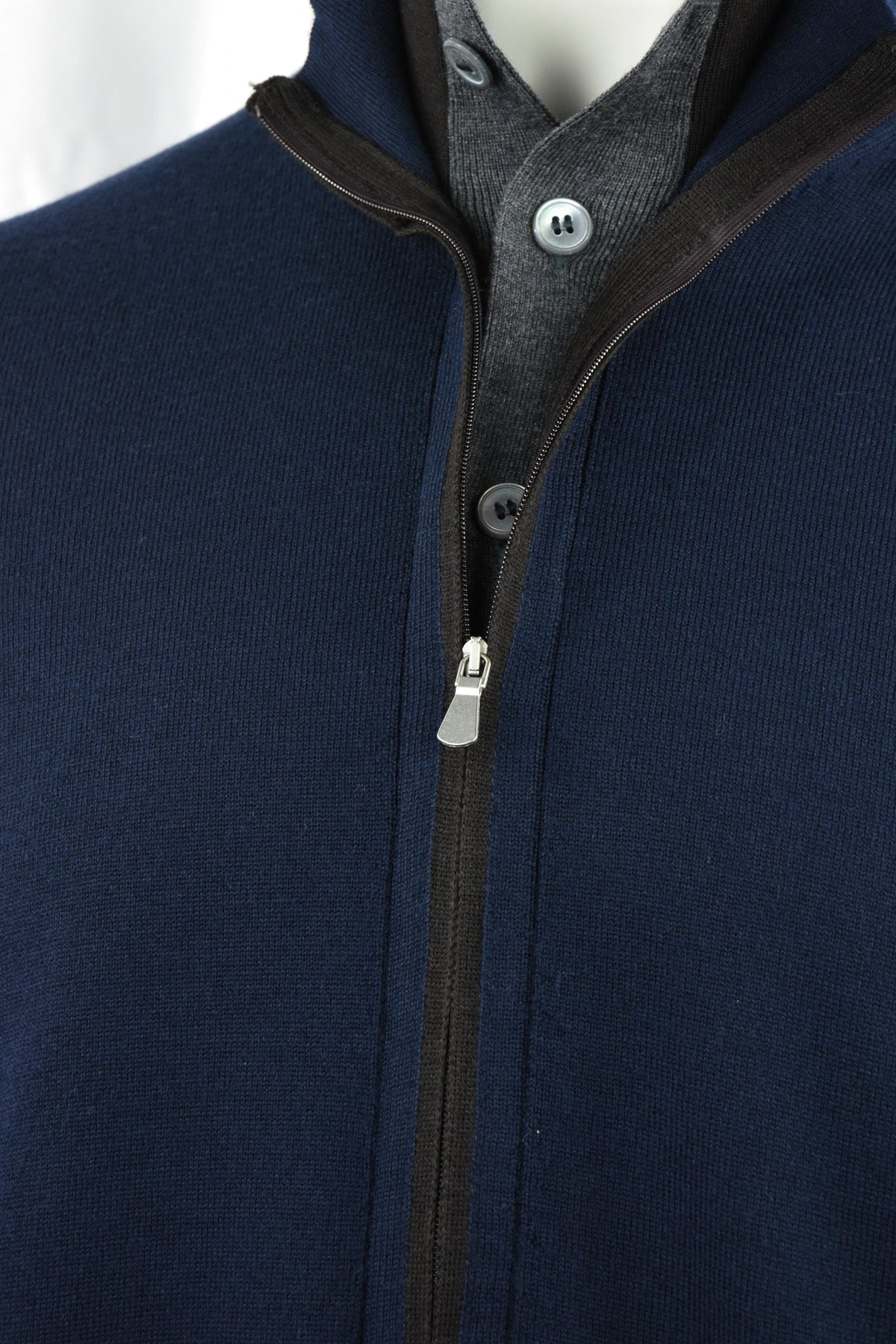 Navy cardigan detail showing the front zip and gray buttoned layer beneath
