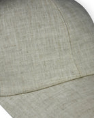Close-up of stone grey linen baseball cap fabric and side seam