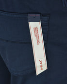 Tramarossa stretch shorts label showing D-FLAX on navy fabric near waistband
