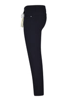 Navy tech five-pocket pants with slim straight leg, side view.
